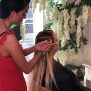 a client receiving tape in hair extensions